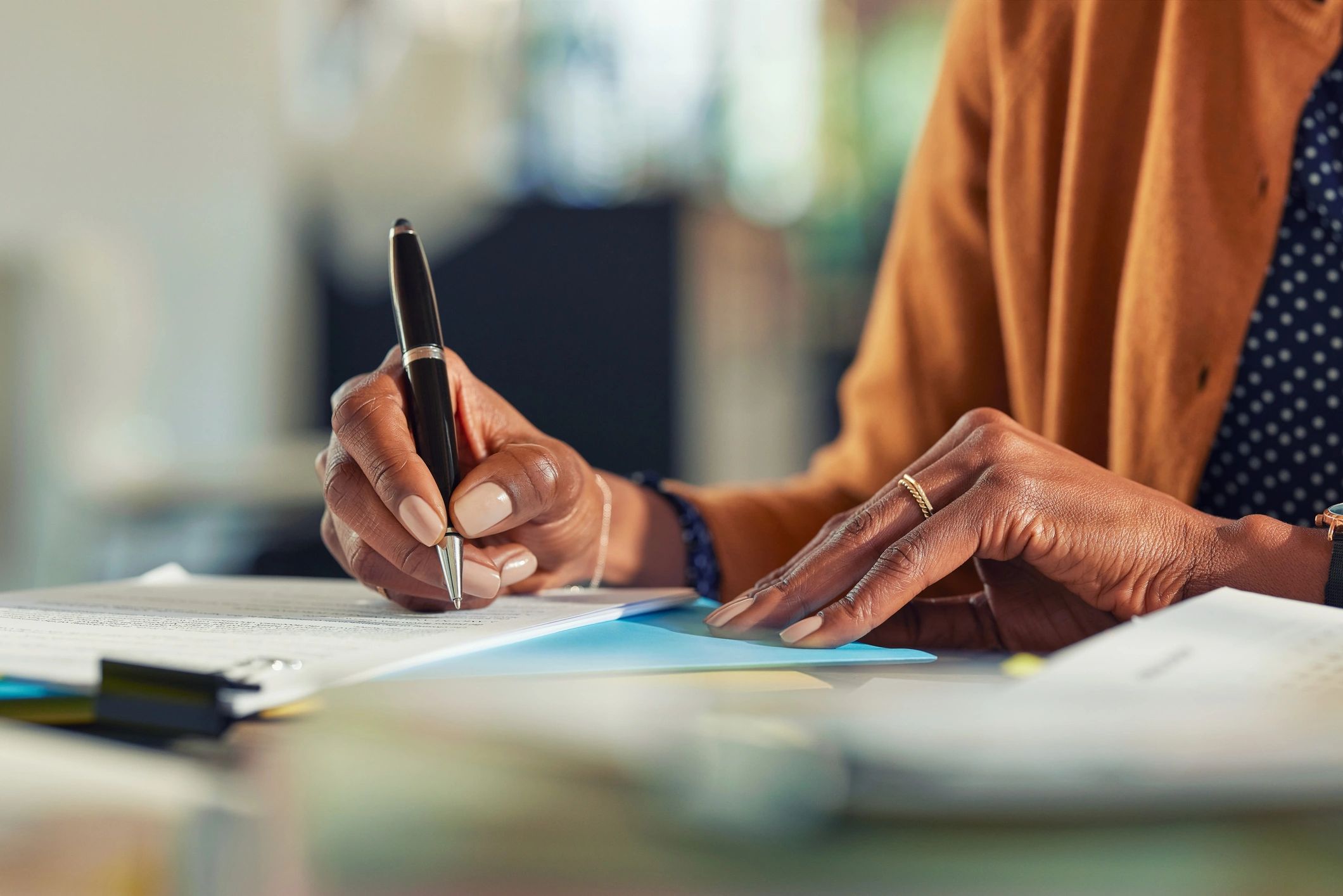 One person signing documents at a desk