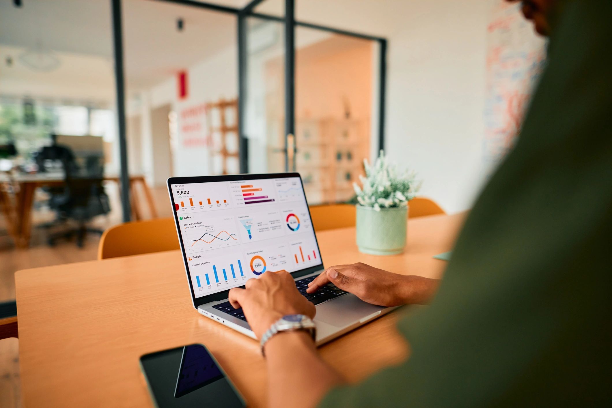 Businessman analyzing financial data on a laptop in a modern office