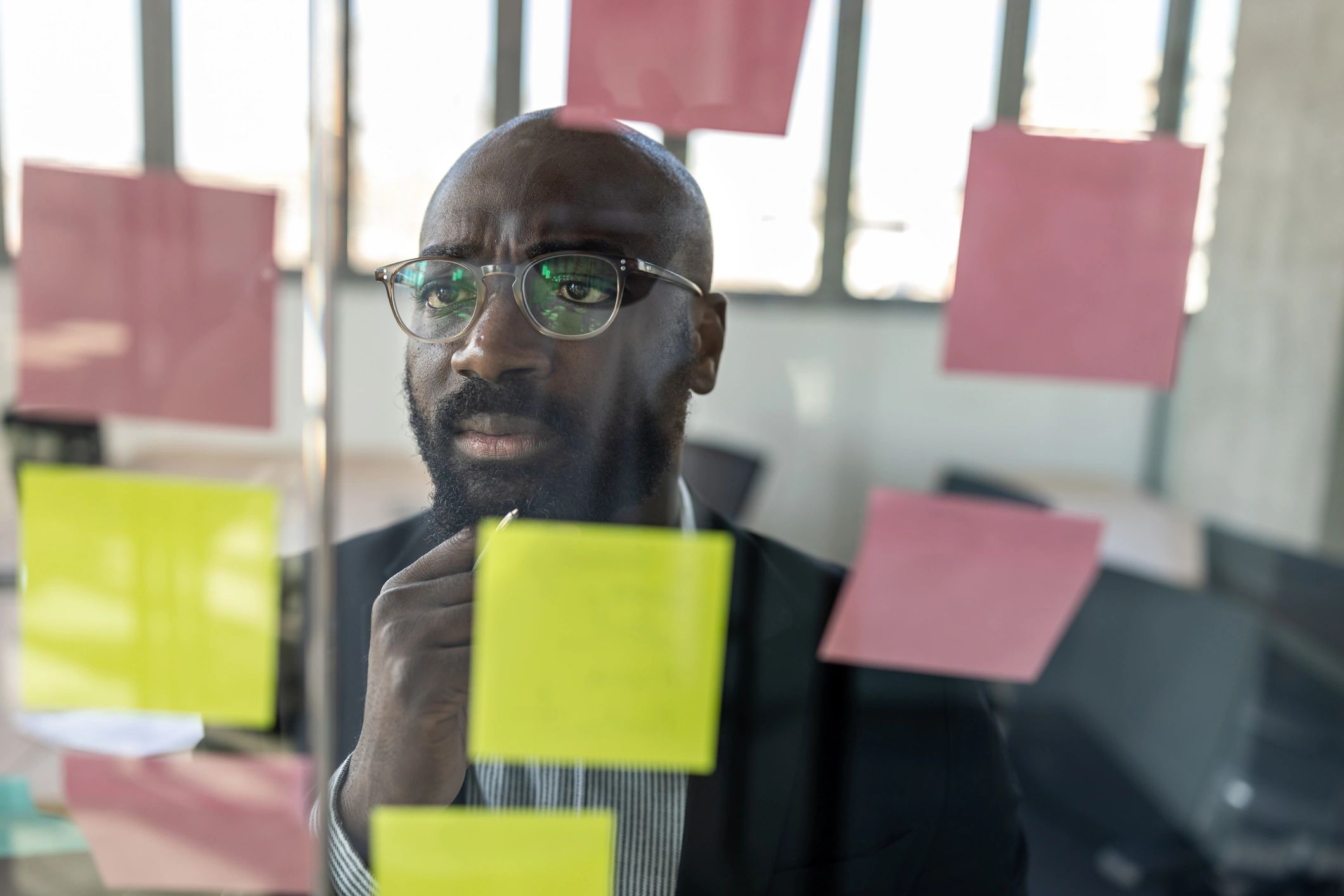 Focused business strategist reviewing sticky notes