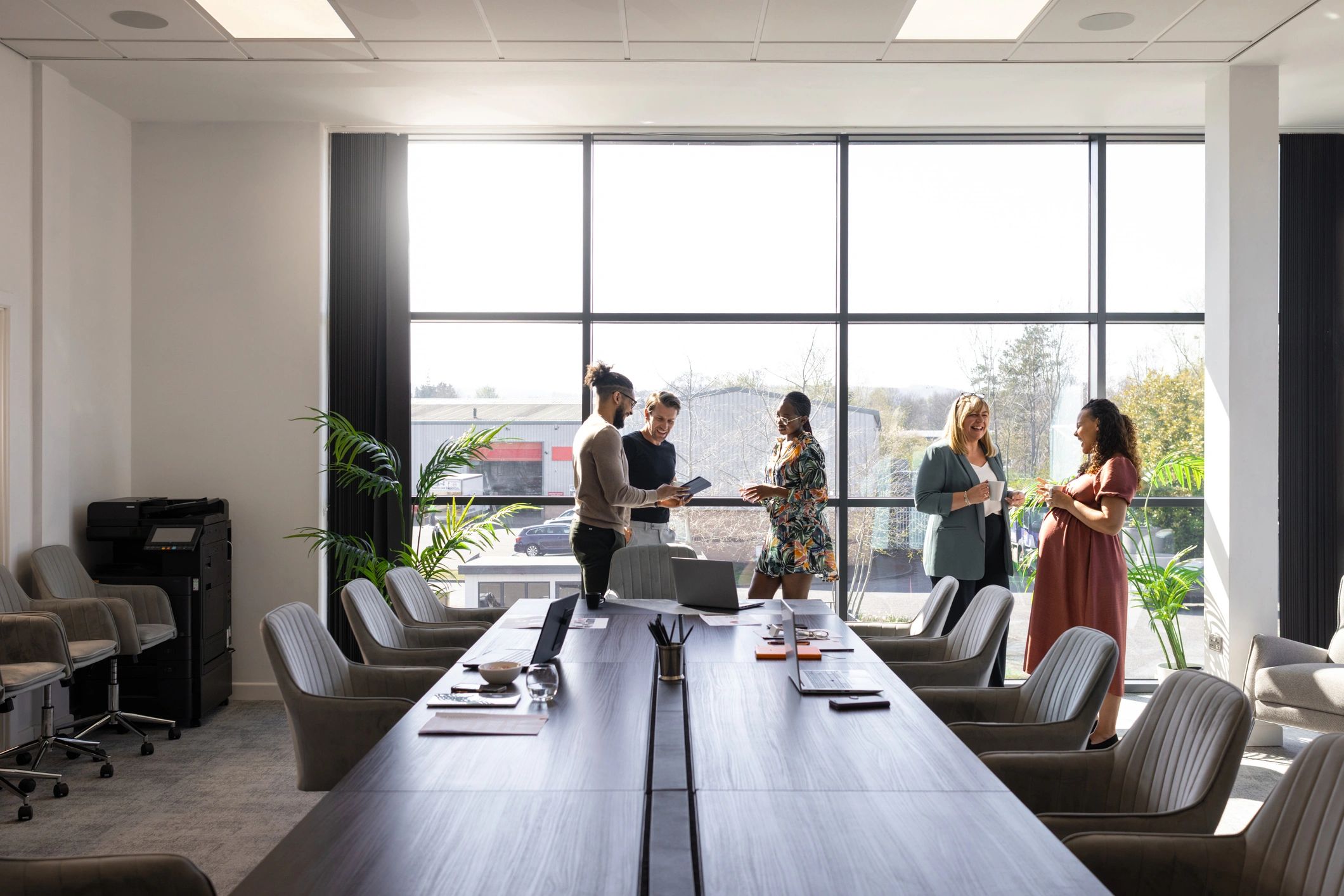 Business colleagues talking together during a break in a conference room